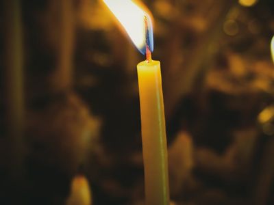 A single candle burning in a quiet meditation room.